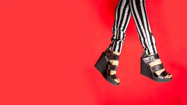 Pernas Femininas Usando Sapatos Verão Sobre Fundo Vermelho Brilhante — Fotografia de Stock