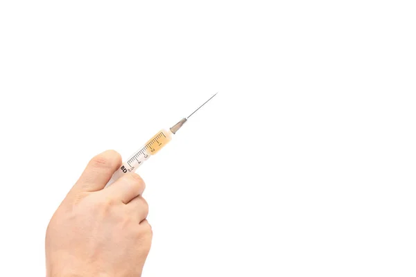 Medical syringe in male hand on white background — 스톡 사진