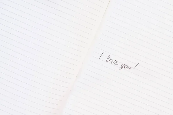 Inscription I love you written on lined notepad — Stock fotografie