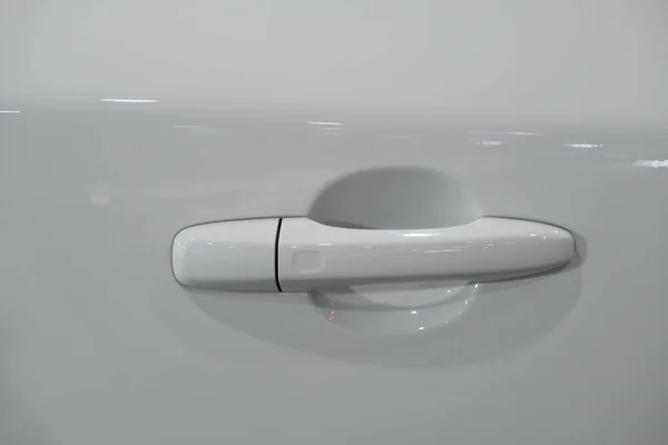 Handle of the door of a luxury white car