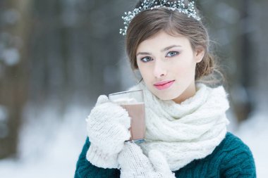 Marshmallow ile sıcak kakao cam fincan tutan genç kadın