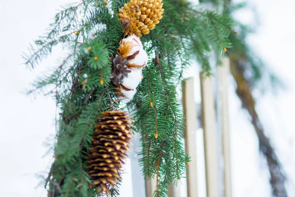 Weihnachten Nadelbaum und Baumwollpflanzenkranz hängen auf Holzschlitten im Freien — Stockfoto