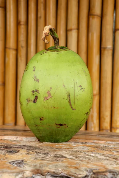 Fresh young coconut on table with massive wooden board. Young Co