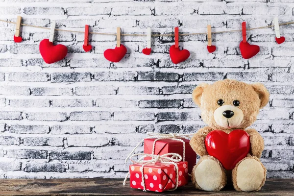 Teddy bear holding a heart-shaped balloon