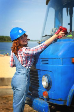 Kot pantolon giymiş kızıl saçlı Avrupalı bir kızın dikey fotoğrafı.