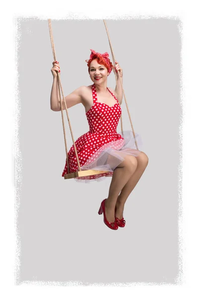 Vertical pin-up photo of a red-haired girl on a swing — 스톡 사진