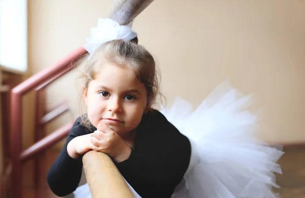 little ballerina sadly looking at the camera