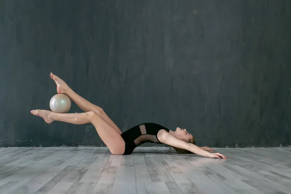 Ten Year Old Gymnast Performs Exercise Ball Lying Floor Dark — Stock Photo, Image