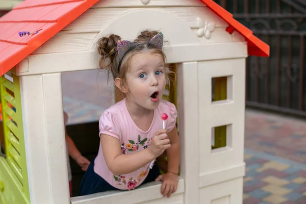 Cheerful Three Year Old Girl Candy Stick Her Hand Looks — Stock Photo, Image