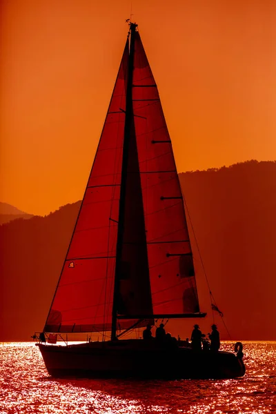 Yacht silhouette in the high sea on sunset — Stock Photo, Image
