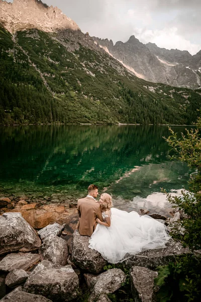 Amazing young couple of lovers on lake Morskie Oko in the Tatra Mountains, in southern Poland