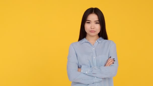 Young girl enjoys on a yellow background. woman emotion of delight — Stock Video