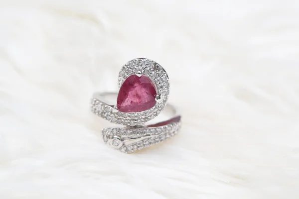 pink gemstone on diamond ring