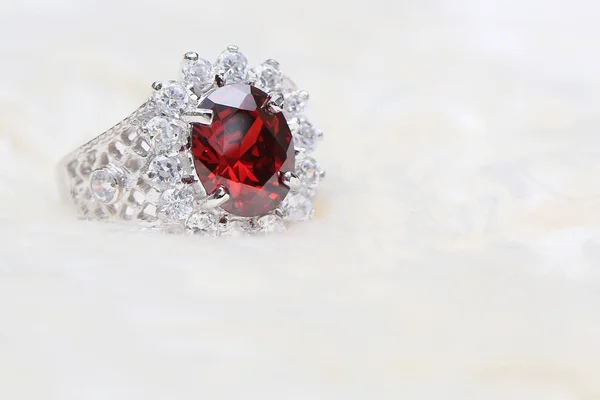 Red gemstone on diamond ring — Stock Photo, Image