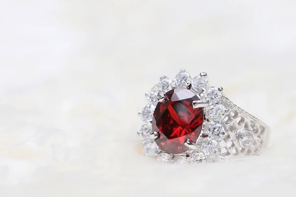 Red gemstone on diamond ring — Stock Photo, Image