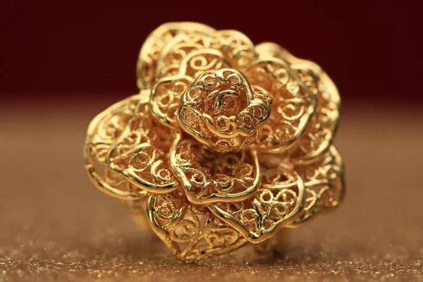 gold rose flower ring on glitter background