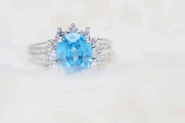 Diamond ring and blue gemstone — Stock Photo, Image