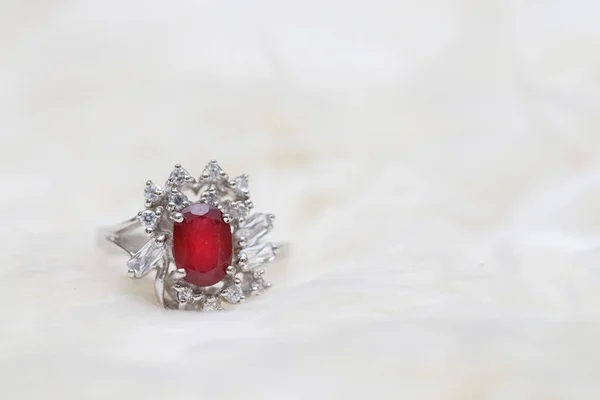 Red gemstone on diamond ring — Stock Photo, Image