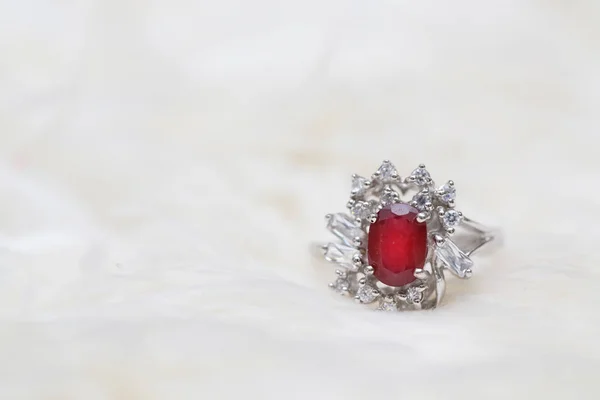 Red gemstone on diamond ring — Stock Photo, Image