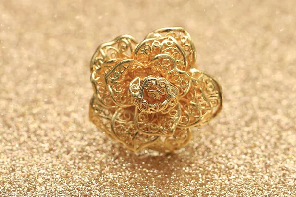 Gold rose flower ring on glitter background Stock Photo