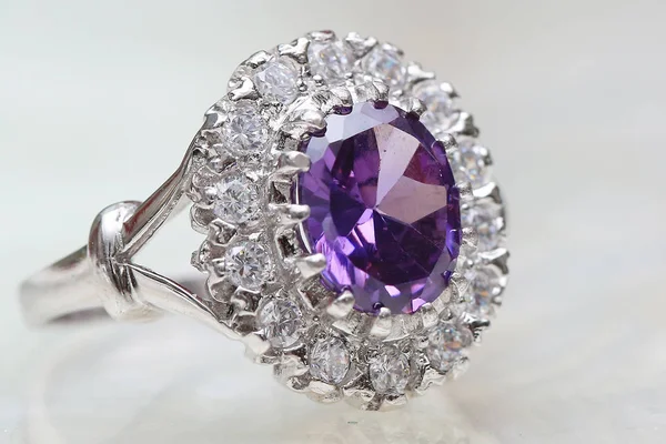 Diamond ring and purple gemstone — Stock Photo, Image