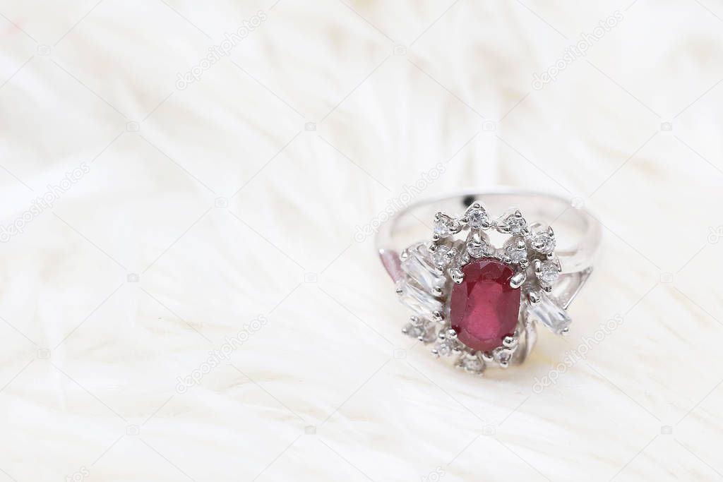 red gemstone on diamond ring