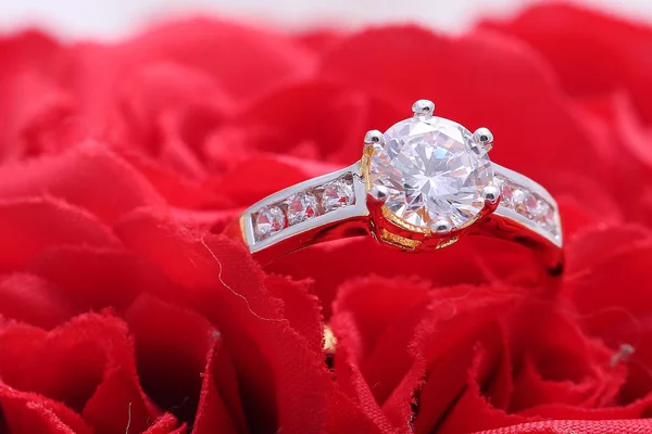 Золоте кільце з діамантом і перлиною, червона троянда — стокове фото