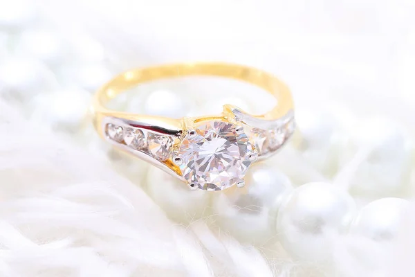 Golden ring with diamond and pearl — Stock Photo, Image