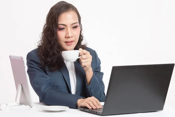 Beautiful young executive with her work and coffee