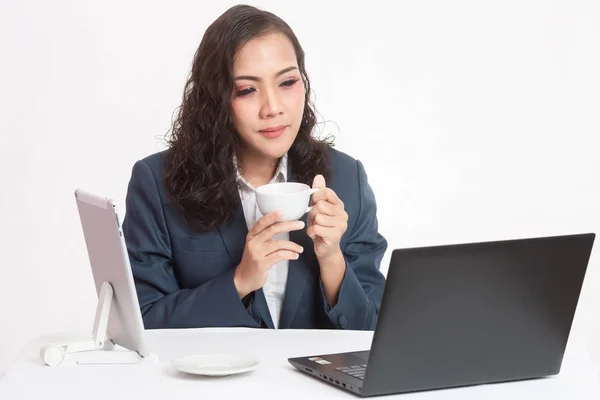 Beautiful young executive with her work and coffee