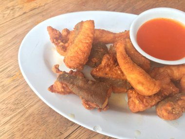 Yatay portre fotoğrafı balık ahşap masa üzerinde chili soslu kızarmış. Sığ derinlik-in tarla.