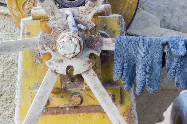 Pair of gloves on the cement mixer in the construction site, horizontal photo — Stock Photo, Image