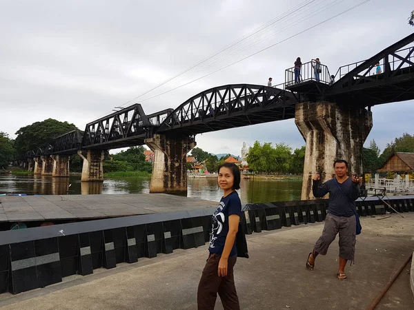 KANCHANABURI, TAILANDIA - 26 DE NOVIEMBRE: Mujer asiática no identificada tomando fotografías bajo el puente sobre el río Kwai el 26 de noviembre de 2016 en Kanchanaburi, Tailandia — Foto de Stock