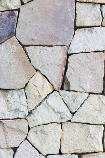 Multi-colored and multi-sized, pale rocks wall grunge texture background. — Stock Photo, Image