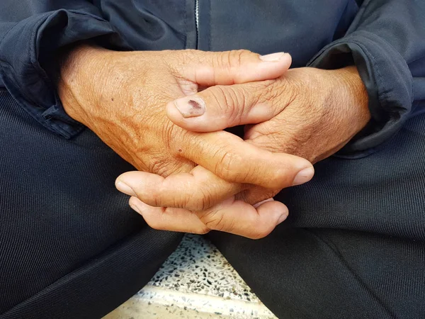 closeup  asian hands clasped together