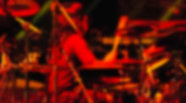 Colorful defocused blurred man playing drum in rock concert background — Stock Photo, Image