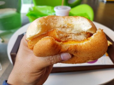 bir balık hamburger bir dükkanda tutan closeup Asya el