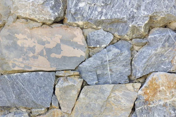 Old colorful wall with stones of different shapes and sizes. — Stock Photo, Image