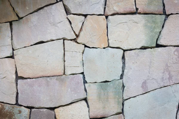 Multi-colored and multi-sized, pale rocks wall grunge texture background. — Stock Photo, Image