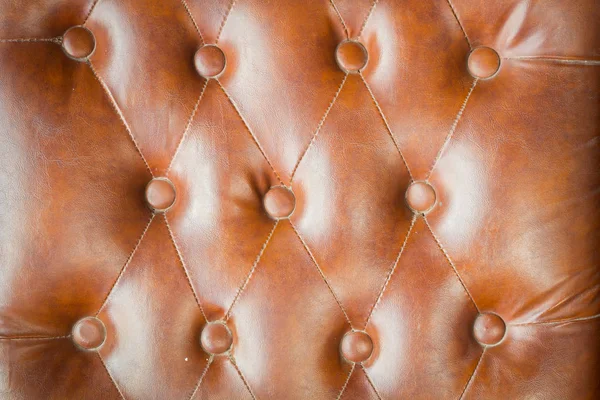 Texture in pelle marrone del divano primo piano colpo . — Foto Stock