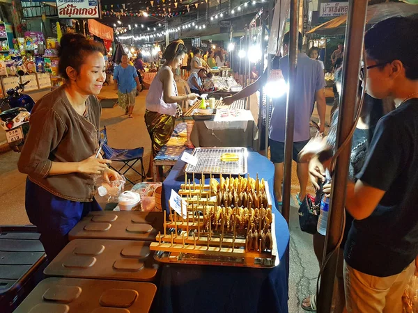 КАМФАЕНГ-ФЕТ, ТАЙЛАНД - 6 мая: неопознанная азиатская женщина в традиционной тайской одежде, продающая еду на рынке Накхончум ночью 6 мая 2017 года в Кампхенг Пхет, Таиланд . — стоковое фото