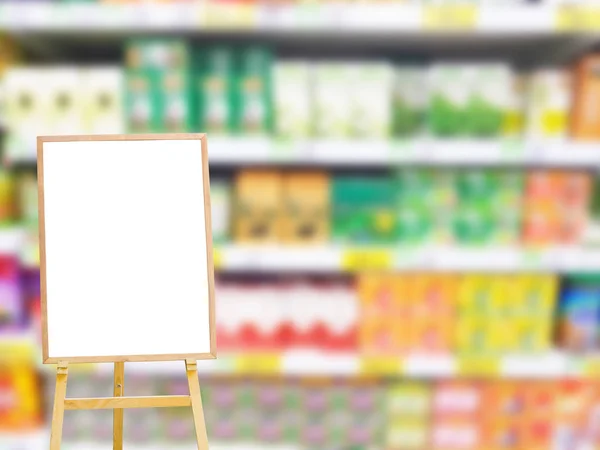 white blank or empty isolated menu board on the left on blurred colorful products on the shelf in supermarket