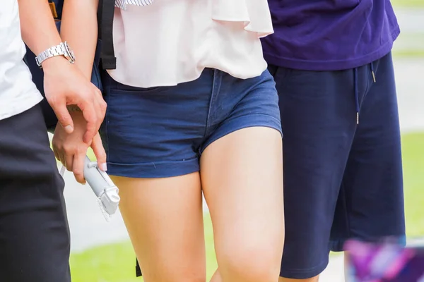 Close-up of walking asian woman wearing denim shorts blue jeans — Stock Photo, Image