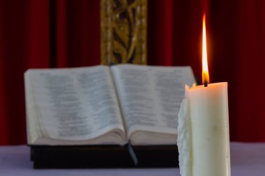 mum ışığı ile gece açık İncil kitap üzerinde
