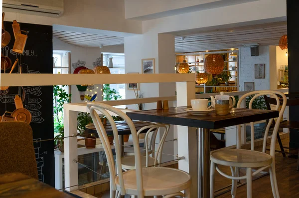 The interior of the cafe is vintage with wicker chandeliers, wooden furniture and design elements. — 스톡 사진