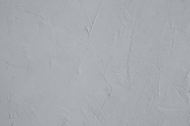 Yüzeyin yakın plan görüntüsü alçı dokusuyla dolu. Yatay yönelim, seçici odak. 