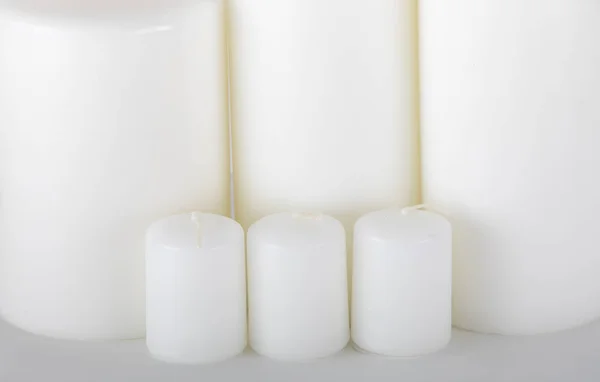 White candles off on a white background