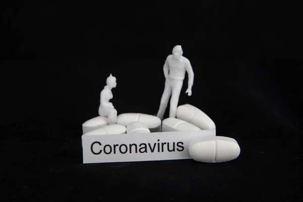 white coronavirus pills with sick people on black background