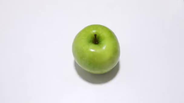 Main Prend Une Pomme Verte Sur Fond Blanc — Video