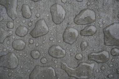 Rain water droplets repelled on new cement surface clipart